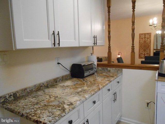 603 Bloomfield Dr, Westampton, NJ 08060 - kitchen with white cabinets, light stone counters, and a chandelier