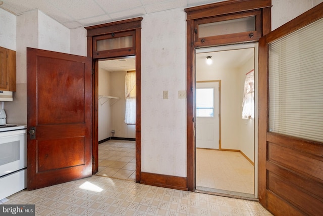 kitchen with a paneled ceiling and white electric range