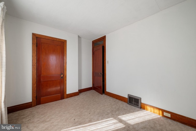 unfurnished bedroom featuring light colored carpet