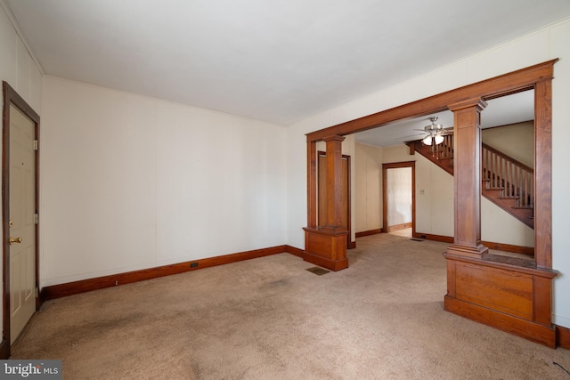 unfurnished living room with ceiling fan, light colored carpet, and ornate columns