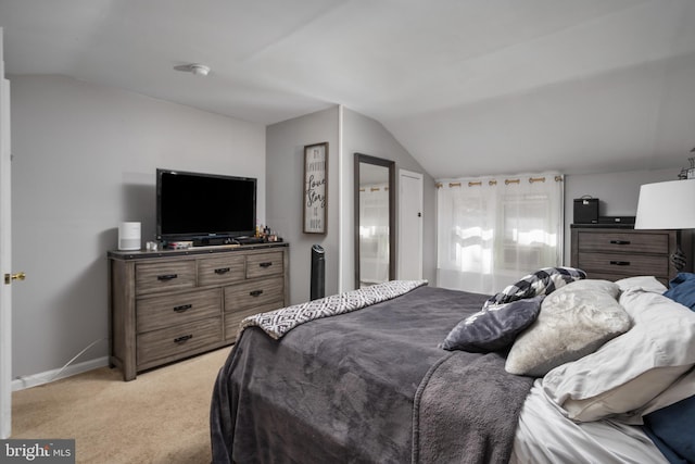 carpeted bedroom featuring lofted ceiling