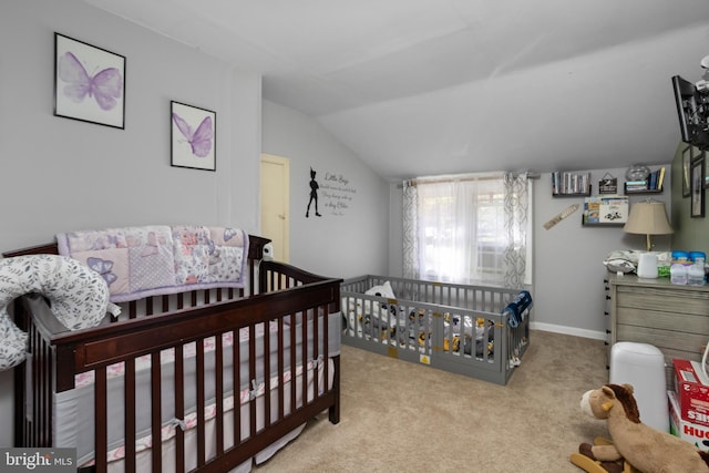 carpeted bedroom with a nursery area and lofted ceiling