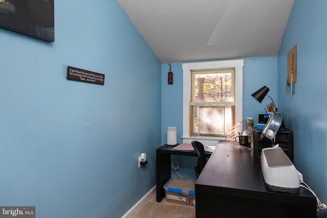 home office with vaulted ceiling and carpet floors