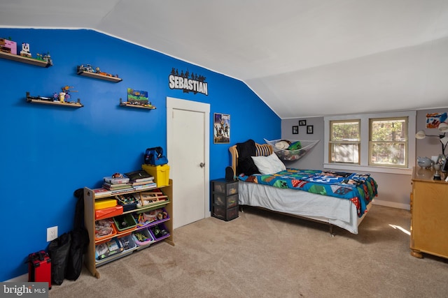 carpeted bedroom with lofted ceiling