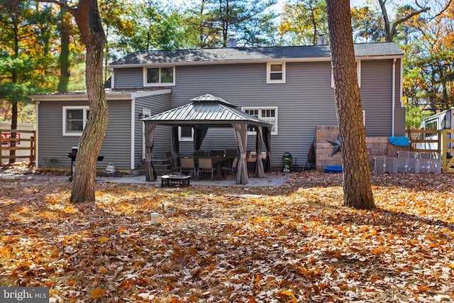 back of property with a patio and a gazebo