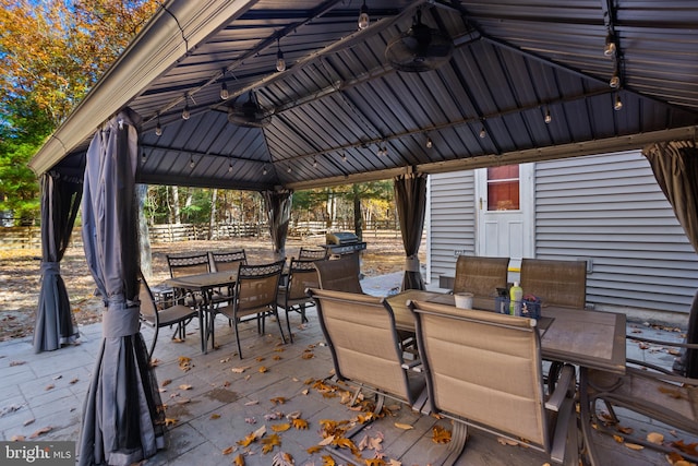 wooden terrace featuring a gazebo