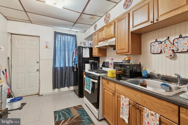 kitchen with gas range gas stove, a drop ceiling, sink, and light tile patterned flooring