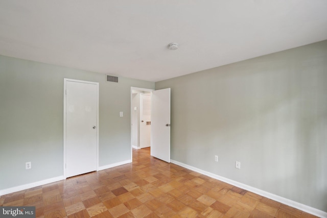 unfurnished bedroom featuring light parquet floors