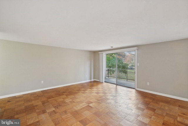 unfurnished room with parquet flooring