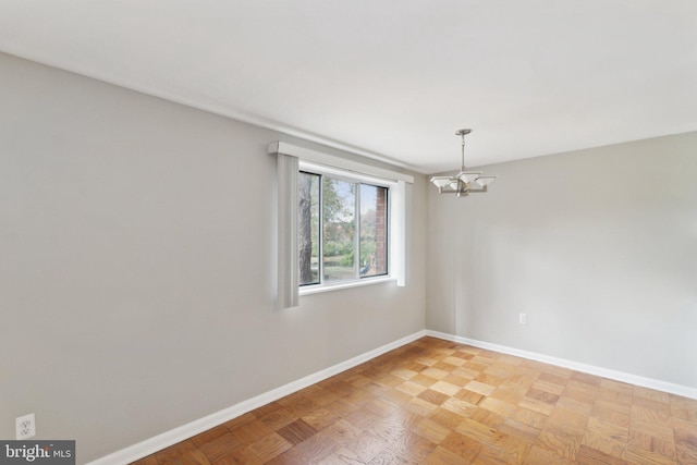 spare room with an inviting chandelier