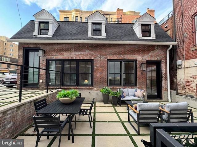 back of house featuring outdoor lounge area and a patio area