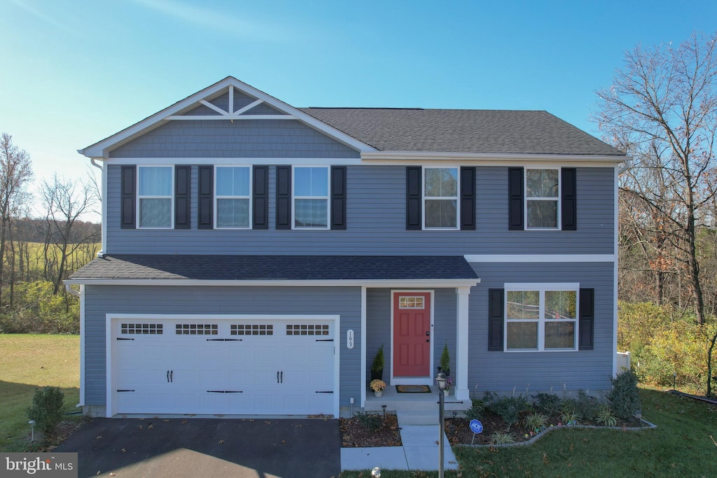 view of front facade featuring a garage and a front yard