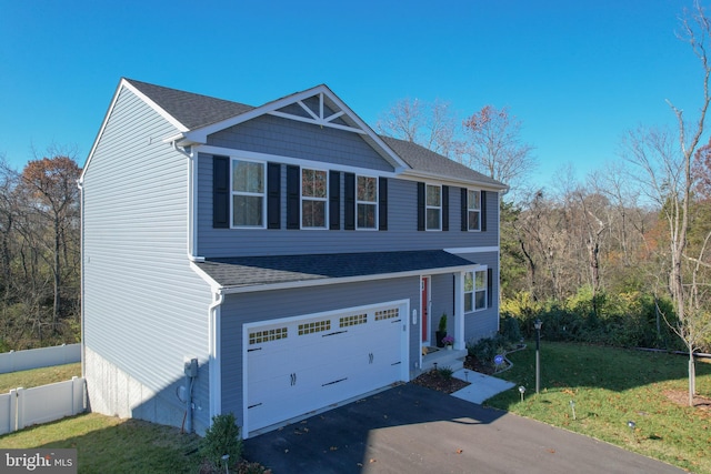 view of front of house with a front yard and a garage