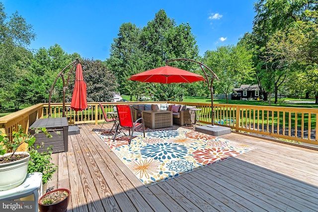 deck with outdoor lounge area and a yard