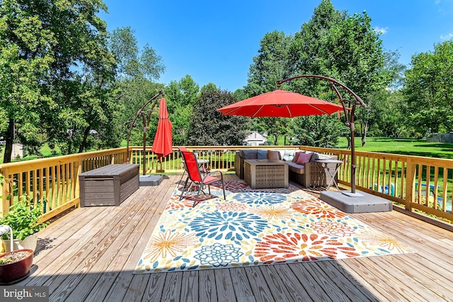 wooden terrace with outdoor lounge area and a lawn