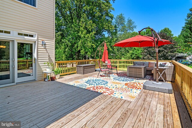 wooden deck with an outdoor living space