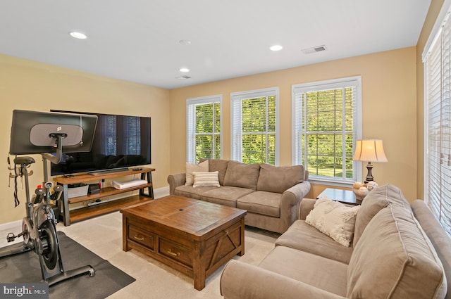 living room with a wealth of natural light and light colored carpet