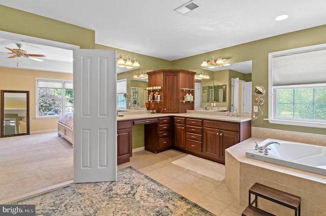 bathroom featuring tile patterned flooring, a wealth of natural light, vanity, and ceiling fan