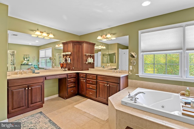 bathroom featuring vanity, tiled tub, and tile patterned floors