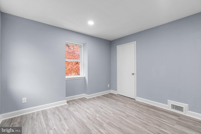 spare room featuring light hardwood / wood-style flooring