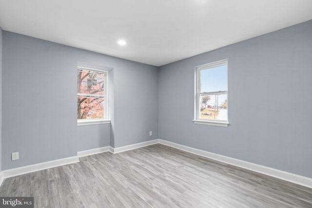 unfurnished room featuring light hardwood / wood-style flooring and a wealth of natural light