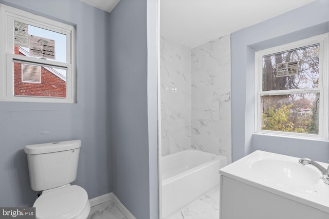 bathroom featuring a bathing tub, vanity, and toilet