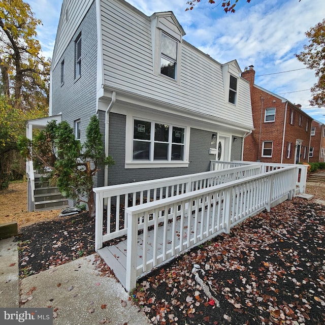 back of house with a deck