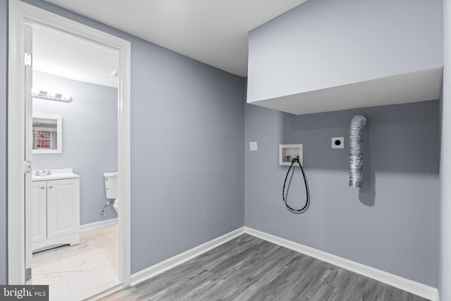 laundry room featuring electric dryer hookup, wood-type flooring, sink, and hookup for a washing machine