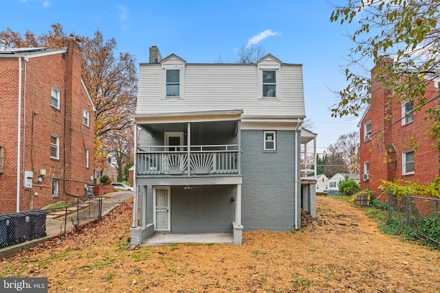 back of property featuring a patio area and a balcony