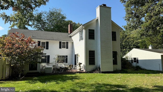 back of house with a lawn