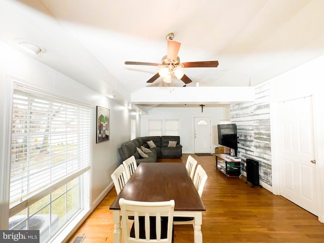 dining space with hardwood / wood-style flooring and ceiling fan