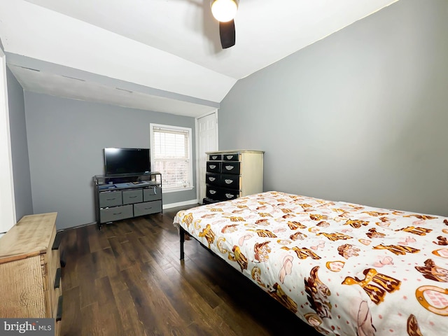 bedroom with ceiling fan, vaulted ceiling, and dark hardwood / wood-style floors