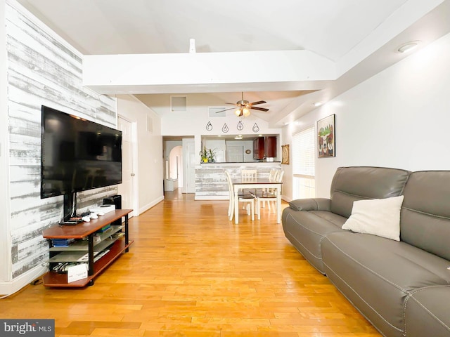 living room featuring wood-type flooring and ceiling fan