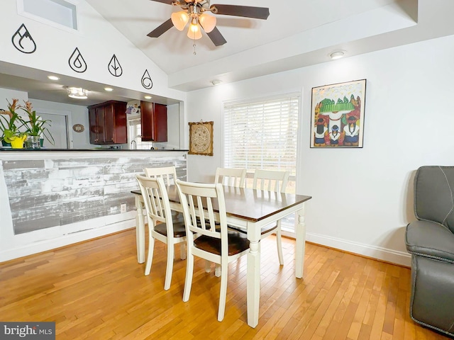 dining area with lofted ceiling, ceiling fan, and light hardwood / wood-style flooring