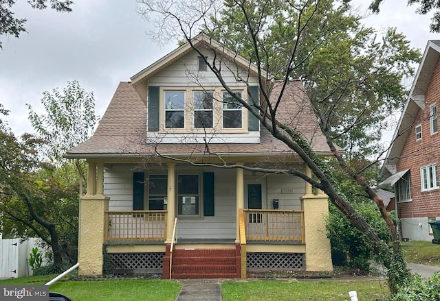 bungalow-style house with a porch and a front yard