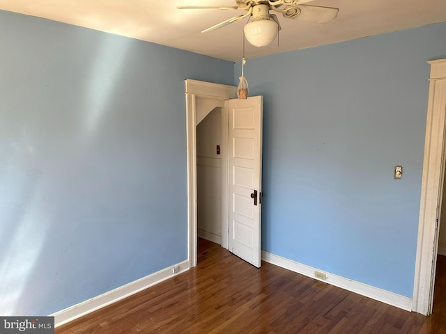 spare room featuring ceiling fan and dark hardwood / wood-style flooring