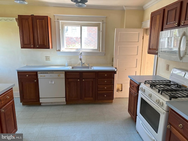 kitchen featuring crown molding, sink, and white appliances