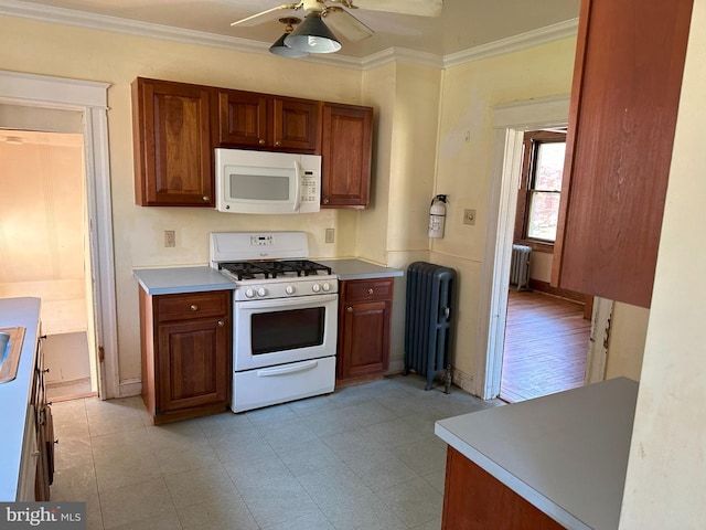 kitchen with crown molding, radiator heating unit, ceiling fan, and white appliances