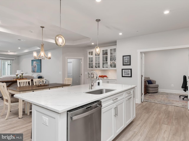 kitchen featuring dishwasher, light hardwood / wood-style floors, white cabinetry, and a kitchen island with sink