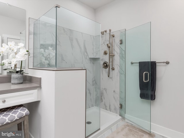 bathroom featuring vanity and an enclosed shower