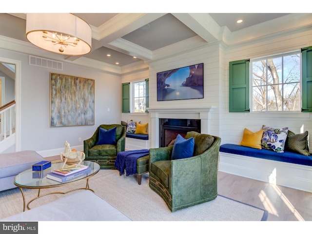 living room with hardwood / wood-style floors, beam ceiling, and crown molding