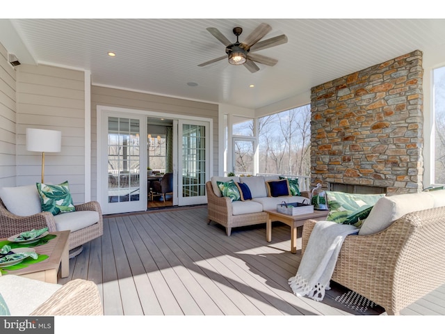 wooden deck featuring an outdoor hangout area and ceiling fan