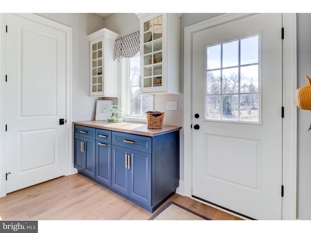 doorway featuring a wealth of natural light and light hardwood / wood-style floors