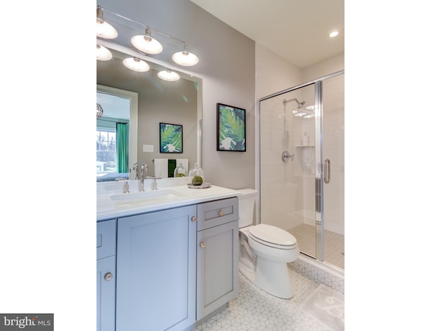 bathroom featuring toilet, vanity, an enclosed shower, and tile patterned floors