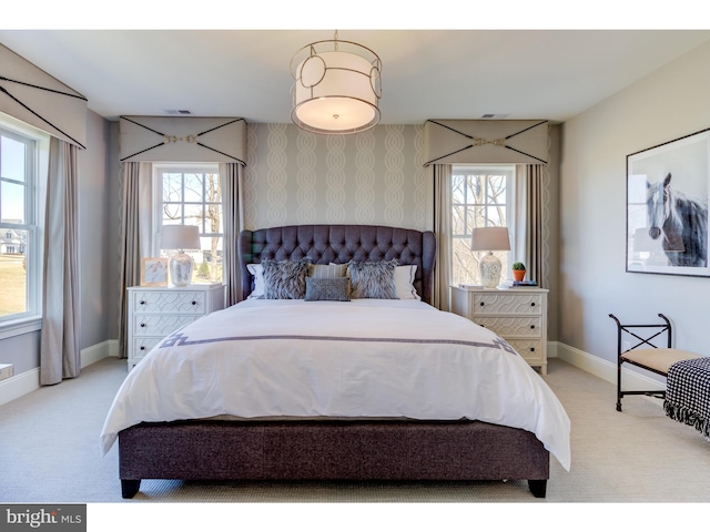 bedroom featuring light colored carpet and multiple windows