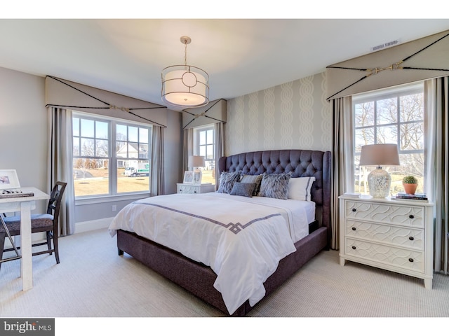 bedroom with carpet flooring and multiple windows