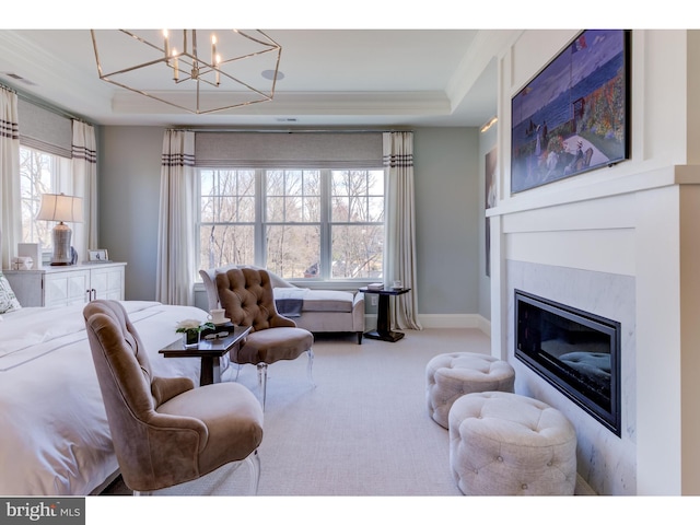 living room featuring a wealth of natural light, a raised ceiling, carpet floors, and a notable chandelier