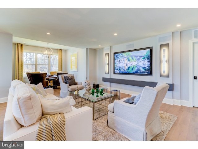 living room featuring light hardwood / wood-style floors and a chandelier