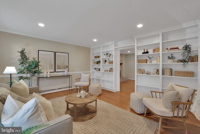 living room featuring light hardwood / wood-style floors and a brick fireplace