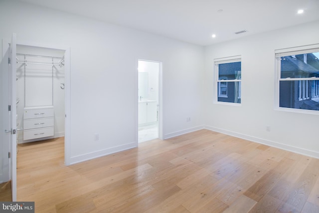 unfurnished bedroom with light hardwood / wood-style floors and a closet